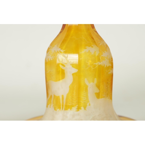 3 - A FINE PAIR OF 19TH CENTURY BOHEMIAN AMBER FLASHED GLASS DECANTERS decorated with Stags amongst wood... 