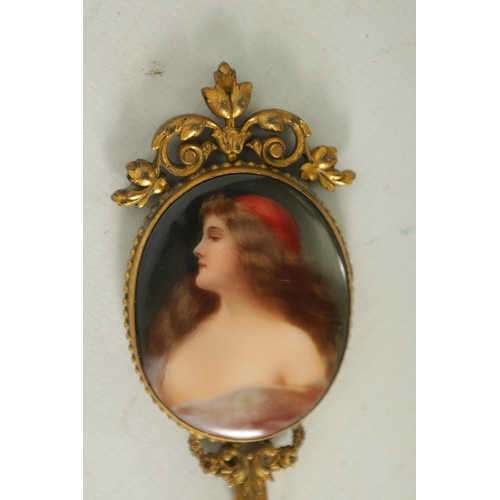 30 - A LATE 19TH CENTURY VIENNA PORCELAIN AND GILT METAL MINIATURE HAND MIRROR the oval convex plaque pai... 