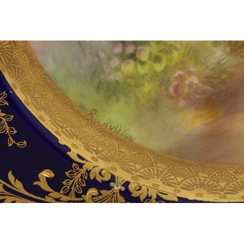 42 - A ROYAL WORCESTER CABINET PLATE PAINTED BY R RUSHTON the scalloped richly gilt Royal Blue border wit... 