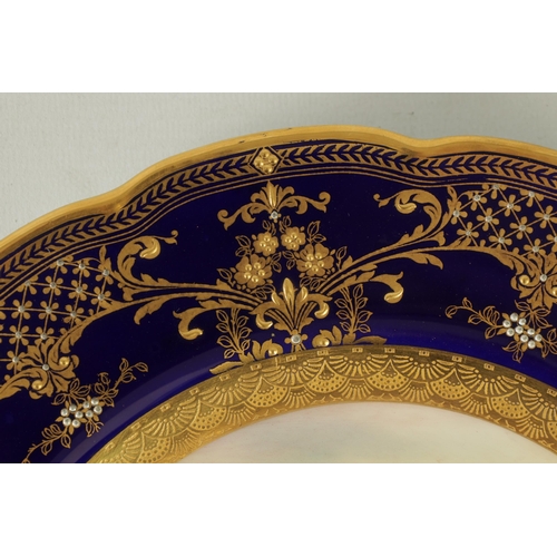 42 - A ROYAL WORCESTER CABINET PLATE PAINTED BY R RUSHTON the scalloped richly gilt Royal Blue border wit... 