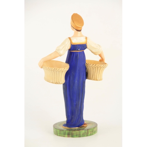 54 - A RUSSIAN PORCELAIN FIGURE depicting a young female carrying baskets mounted on a circular base. (23... 