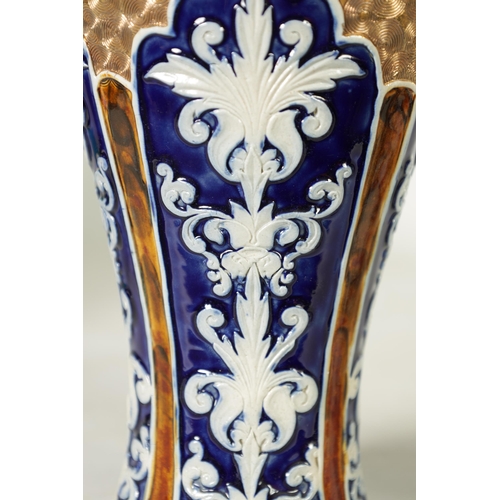 58 - A PAIR OF DOULTON LAMBETH STONEWARE TAPERED SHOULDERED VASES WITH FLARED NECKS decorated with raised... 