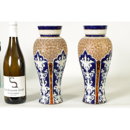 58 - A PAIR OF DOULTON LAMBETH STONEWARE TAPERED SHOULDERED VASES WITH FLARED NECKS decorated with raised... 