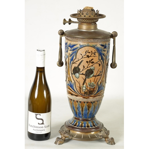 62 - A 19TH-CENTURY DOULTON STONEWARE AND GILT BRASS MOUNTED OIL LAMP DECORATED BY FLORENCE BARLOW the le... 