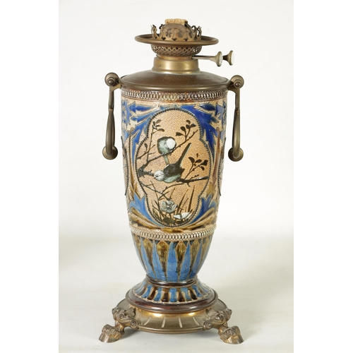 62 - A 19TH-CENTURY DOULTON STONEWARE AND GILT BRASS MOUNTED OIL LAMP DECORATED BY FLORENCE BARLOW the le... 