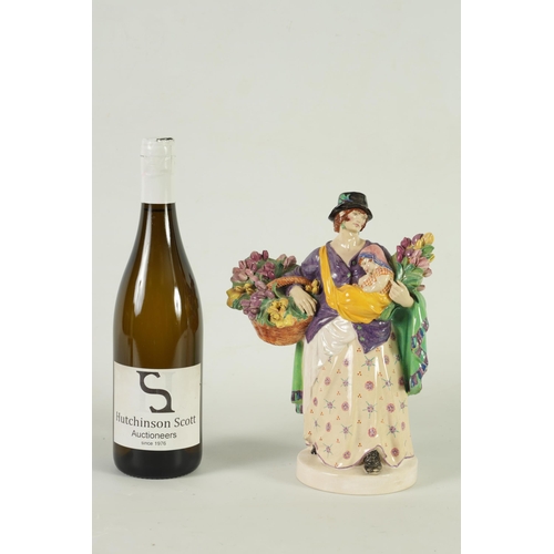 81 - CHARLES VYSE - 1922 A finely modelled earthenware FIGURE depicting a flower seller colourfully decor... 