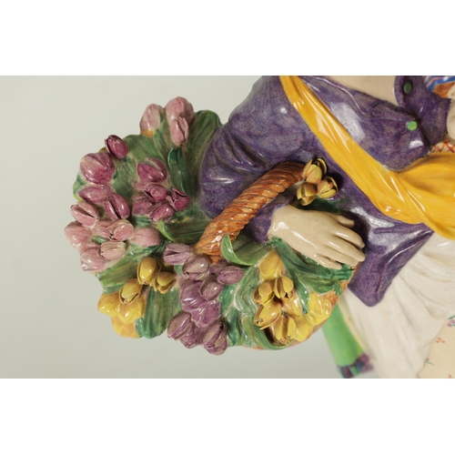 81 - CHARLES VYSE - 1922 A finely modelled earthenware FIGURE depicting a flower seller colourfully decor... 