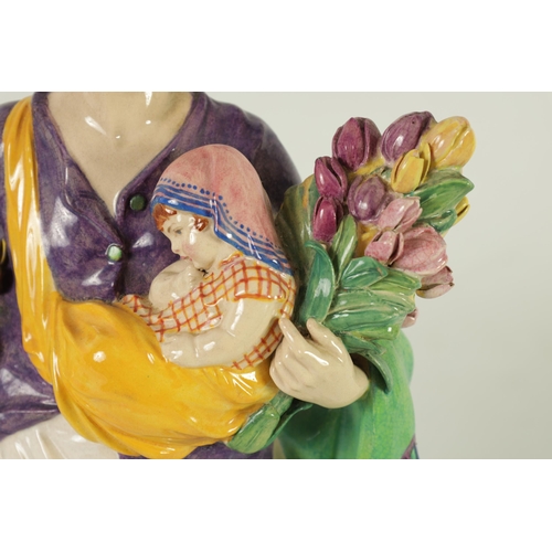 81 - CHARLES VYSE - 1922 A finely modelled earthenware FIGURE depicting a flower seller colourfully decor... 
