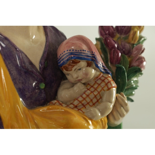 81 - CHARLES VYSE - 1922 A finely modelled earthenware FIGURE depicting a flower seller colourfully decor... 