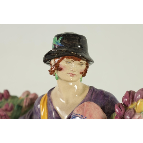 81 - CHARLES VYSE - 1922 A finely modelled earthenware FIGURE depicting a flower seller colourfully decor... 