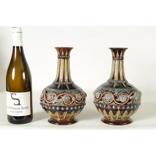 92 - A GOOD PAIR OF DOULTON LAMBETH FOOTED BULBOUS FLARED NECK VASES BEARING MONOGRAM FOR GEORGE TINWORTH... 