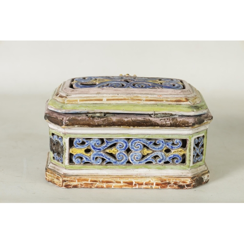 99 - A 17TH/18TH CENTURY POLYCHROME CONTINENTAL MAJOLICA CASKET AND COVER of canted rectangular form with... 