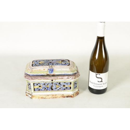 99 - A 17TH/18TH CENTURY POLYCHROME CONTINENTAL MAJOLICA CASKET AND COVER of canted rectangular form with... 