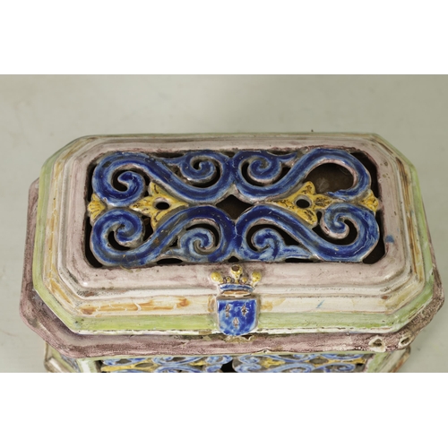 99 - A 17TH/18TH CENTURY POLYCHROME CONTINENTAL MAJOLICA CASKET AND COVER of canted rectangular form with... 