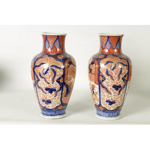 302 - A GOOD LARGE PAIR OF 19TH CENTURY IMARI TAPERING SHOULDERED VASES decorated in the traditional palet... 