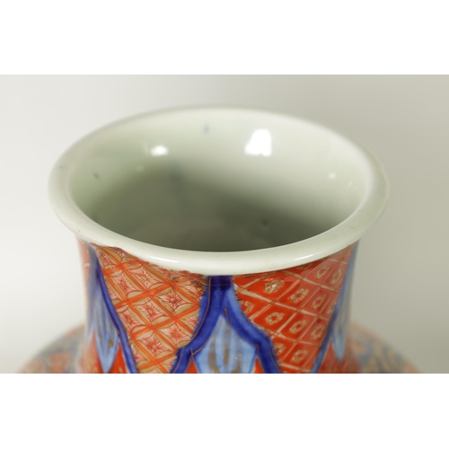 302 - A GOOD LARGE PAIR OF 19TH CENTURY IMARI TAPERING SHOULDERED VASES decorated in the traditional palet... 