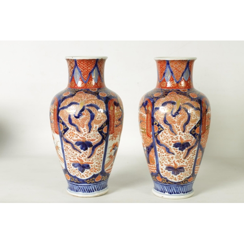 302 - A GOOD LARGE PAIR OF 19TH CENTURY IMARI TAPERING SHOULDERED VASES decorated in the traditional palet... 