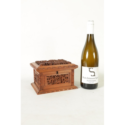 305 - A LATE 19TH CENTURY CHINESE CARVED SANDALWOOD LIDDED JEWELLERY BOX profusely carved with landscape f... 