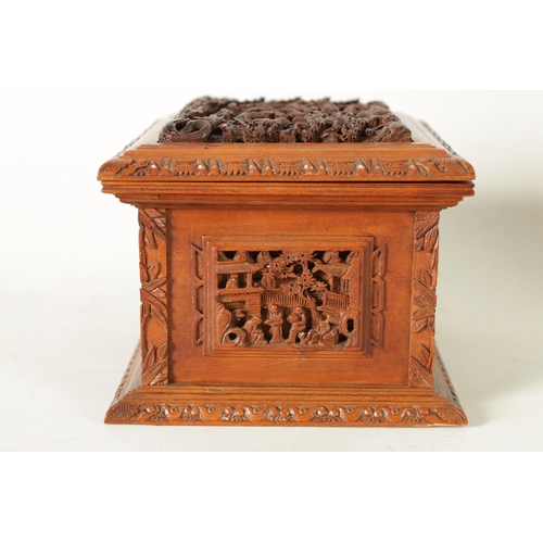 305 - A LATE 19TH CENTURY CHINESE CARVED SANDALWOOD LIDDED JEWELLERY BOX profusely carved with landscape f... 