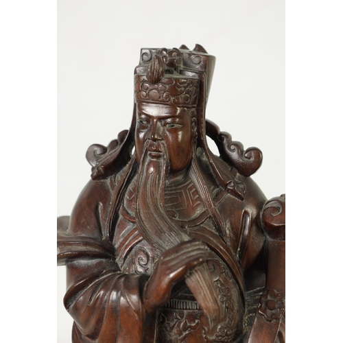 322 - A LATE 19TH CENTURY CHINESE CARVED HARDWOOD FIGURAL SCULPTURE OF AN EMPEROR robed holding a staff. (... 