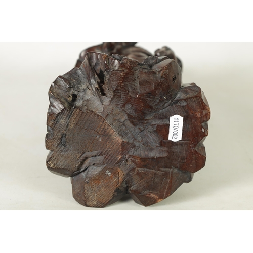 322 - A LATE 19TH CENTURY CHINESE CARVED HARDWOOD FIGURAL SCULPTURE OF AN EMPEROR robed holding a staff. (... 