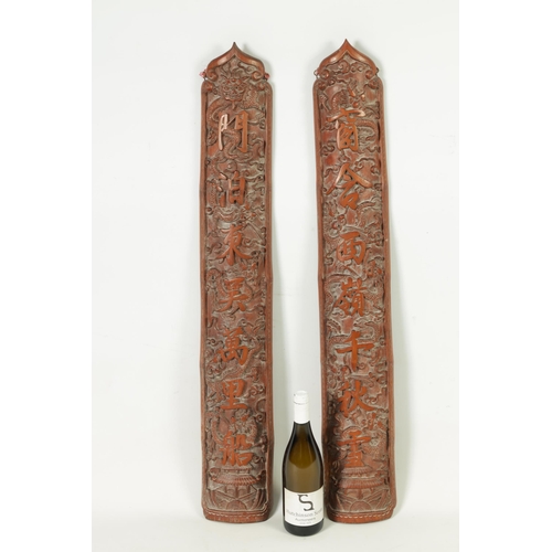 324 - A PAIR OF 19TH CENTURY CHINESE CARVED BAMBOO WALL PLAQUES with character marks and entwined dragons.... 