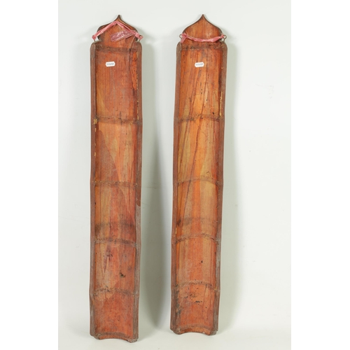 324 - A PAIR OF 19TH CENTURY CHINESE CARVED BAMBOO WALL PLAQUES with character marks and entwined dragons.... 