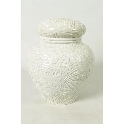 326 - A LARGE JAPANESE MEIJI PERIOD PALE CELADON GLAZE POTTERY VASE AND COVER with overall relief moulded ... 