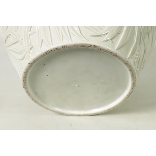 326 - A LARGE JAPANESE MEIJI PERIOD PALE CELADON GLAZE POTTERY VASE AND COVER with overall relief moulded ... 