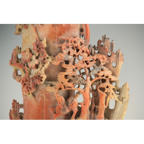 329 - A LATE 19TH CENTURY CHINESE SOAPSTONE VASE ON STAND with finely carved woodland animals amongst tree... 