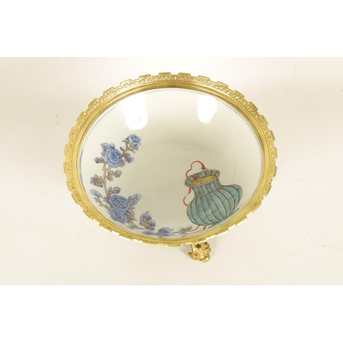 336 - AN ORMOLU MOUNTED CHINESE BOWL pale blue ground with floral decoration enclosing foo dog panels, the... 