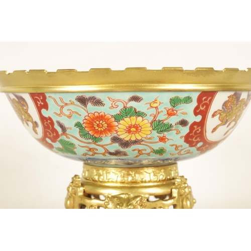 336 - AN ORMOLU MOUNTED CHINESE BOWL pale blue ground with floral decoration enclosing foo dog panels, the... 