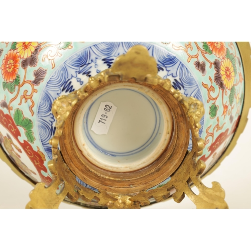 336 - AN ORMOLU MOUNTED CHINESE BOWL pale blue ground with floral decoration enclosing foo dog panels, the... 
