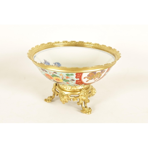 336 - AN ORMOLU MOUNTED CHINESE BOWL pale blue ground with floral decoration enclosing foo dog panels, the... 