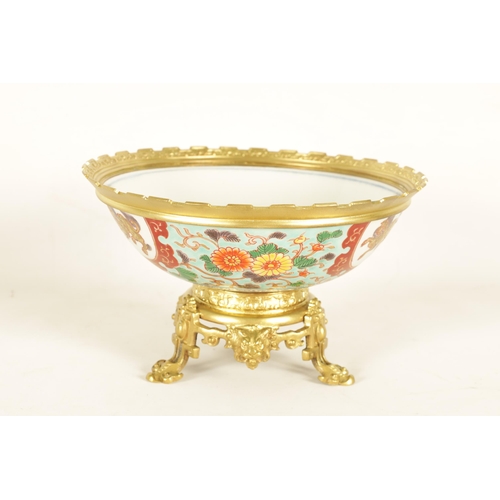 336 - AN ORMOLU MOUNTED CHINESE BOWL pale blue ground with floral decoration enclosing foo dog panels, the... 