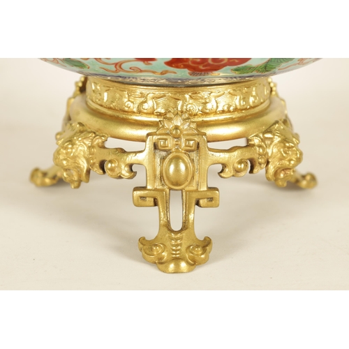 336 - AN ORMOLU MOUNTED CHINESE BOWL pale blue ground with floral decoration enclosing foo dog panels, the... 