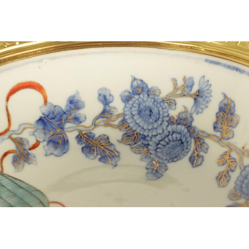 336 - AN ORMOLU MOUNTED CHINESE BOWL pale blue ground with floral decoration enclosing foo dog panels, the... 