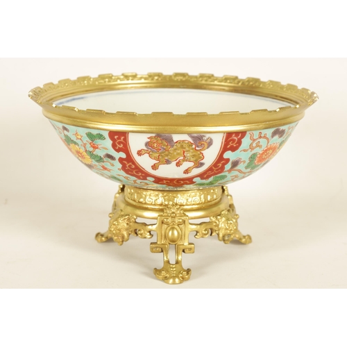 336 - AN ORMOLU MOUNTED CHINESE BOWL pale blue ground with floral decoration enclosing foo dog panels, the... 