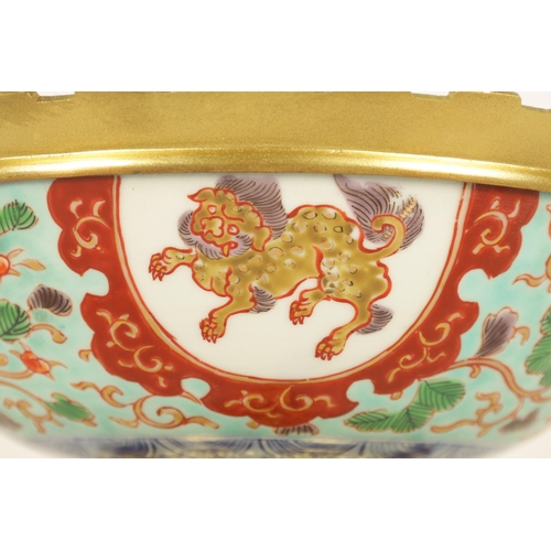 336 - AN ORMOLU MOUNTED CHINESE BOWL pale blue ground with floral decoration enclosing foo dog panels, the... 