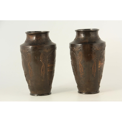 339 - A PAIR OF JAPANESE BRONZE WHITE METAL PANELLED VASES with figural and landscape scenes surrounded by... 