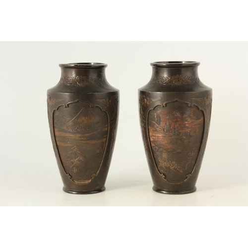 339 - A PAIR OF JAPANESE BRONZE WHITE METAL PANELLED VASES with figural and landscape scenes surrounded by... 