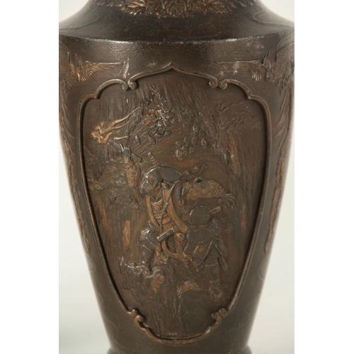 339 - A PAIR OF JAPANESE BRONZE WHITE METAL PANELLED VASES with figural and landscape scenes surrounded by... 