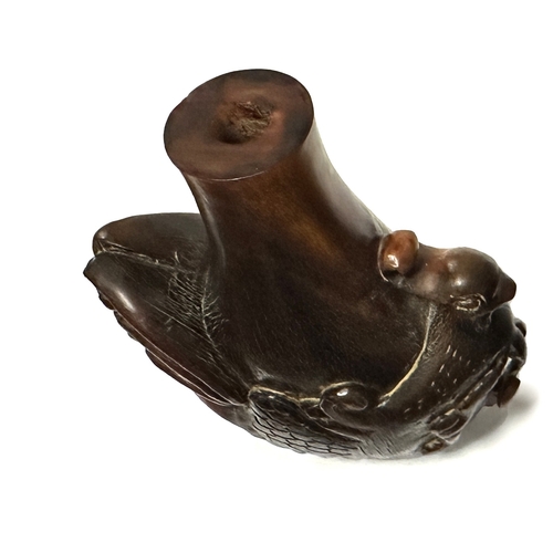 352 - A CHINESE CARVED RHINOCEROS HORN SNUFF BOTTLE modelled as an exotic bird with pierced tail feathers.