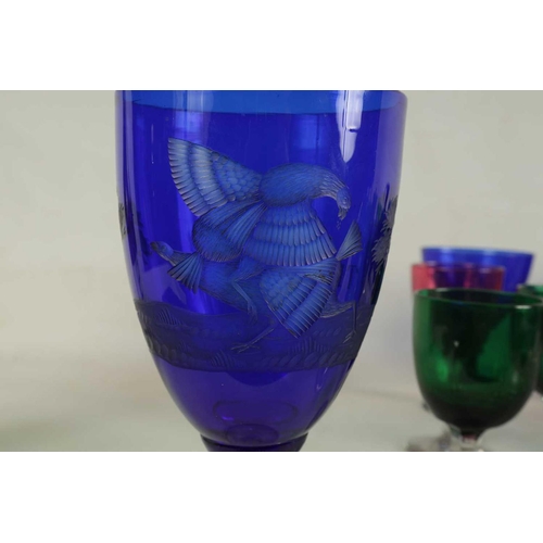 11 - A LARGE COLLECTION OF COLOURED GLASSWARE comprising a `Georgian Bristol blue squat Jug, three later ... 