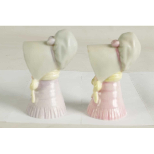22 - OLD WOMAN AND YOUNG GIRL TWO ROYAL WORCESTER CANDLE EXTINGUISHERS Attributed to James Hadley, both w... 