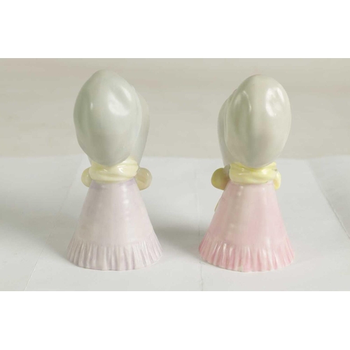 22 - OLD WOMAN AND YOUNG GIRL TWO ROYAL WORCESTER CANDLE EXTINGUISHERS Attributed to James Hadley, both w... 