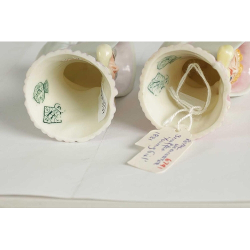 22 - OLD WOMAN AND YOUNG GIRL TWO ROYAL WORCESTER CANDLE EXTINGUISHERS Attributed to James Hadley, both w... 