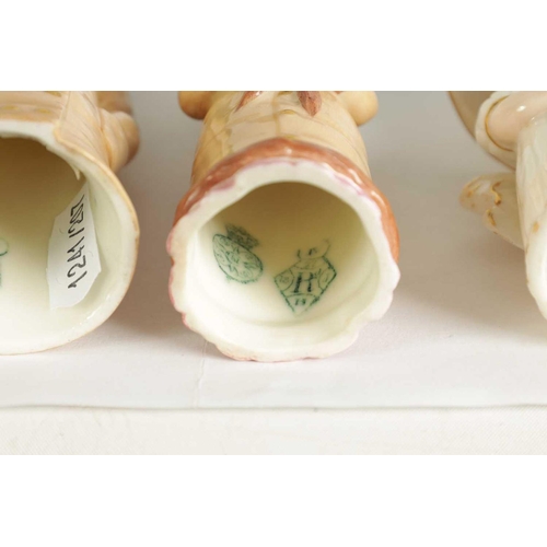 32 - GIRL WITH MUFF AND BOY WITH BOATER. A PAIR OF ROYAL WORCESTER CANDLE EXTINGUISHERS circa 1881 the bo... 