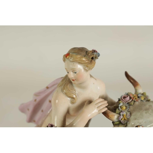 49 - A 19TH CENTURY MEISSEN FIGURE GROUP OF A BULL WITH A SEATED LADY RIDER AND A FLOWER SELLER finely mo... 