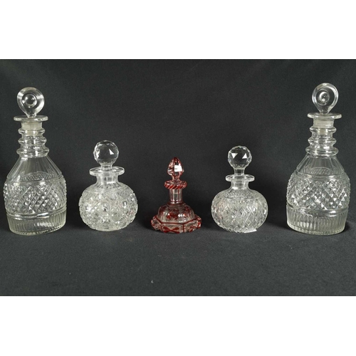 5 - A PAIR OF 19TH CENTURY CUT GLASS DECANTERS with bulls-eye stoppers, triple ringed necks and hobnail-... 